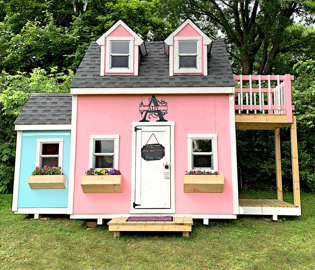 Pink and blue playhouse for girls with dormers, flower boxes and balcony