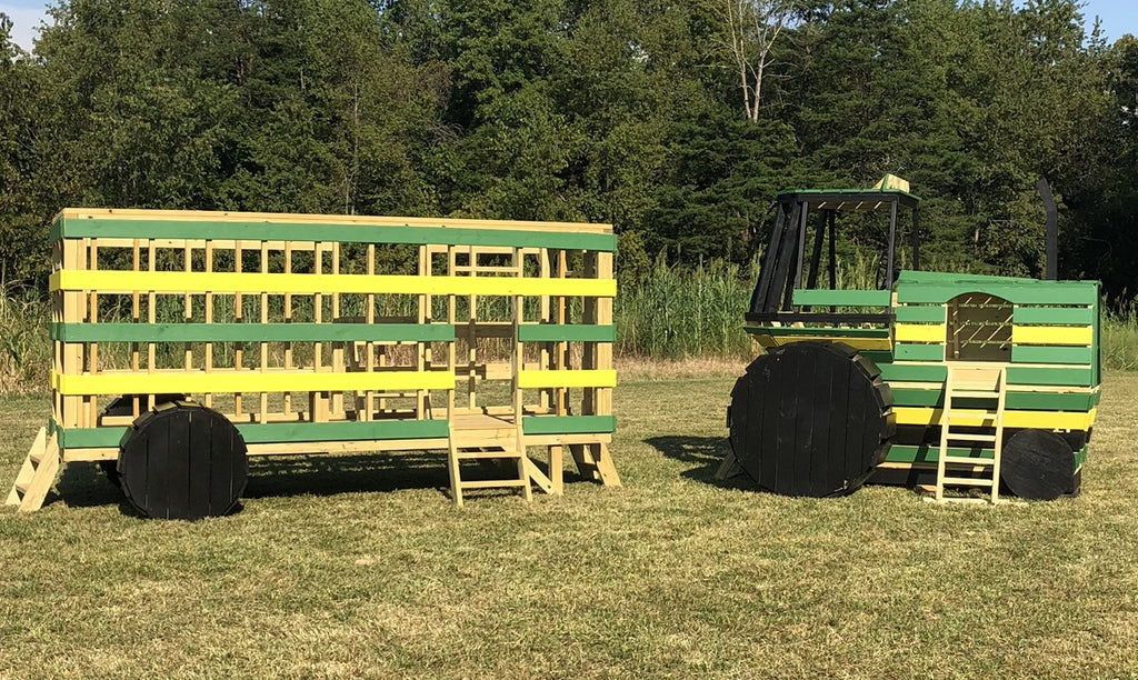 Green tractor and trailer playset in a field