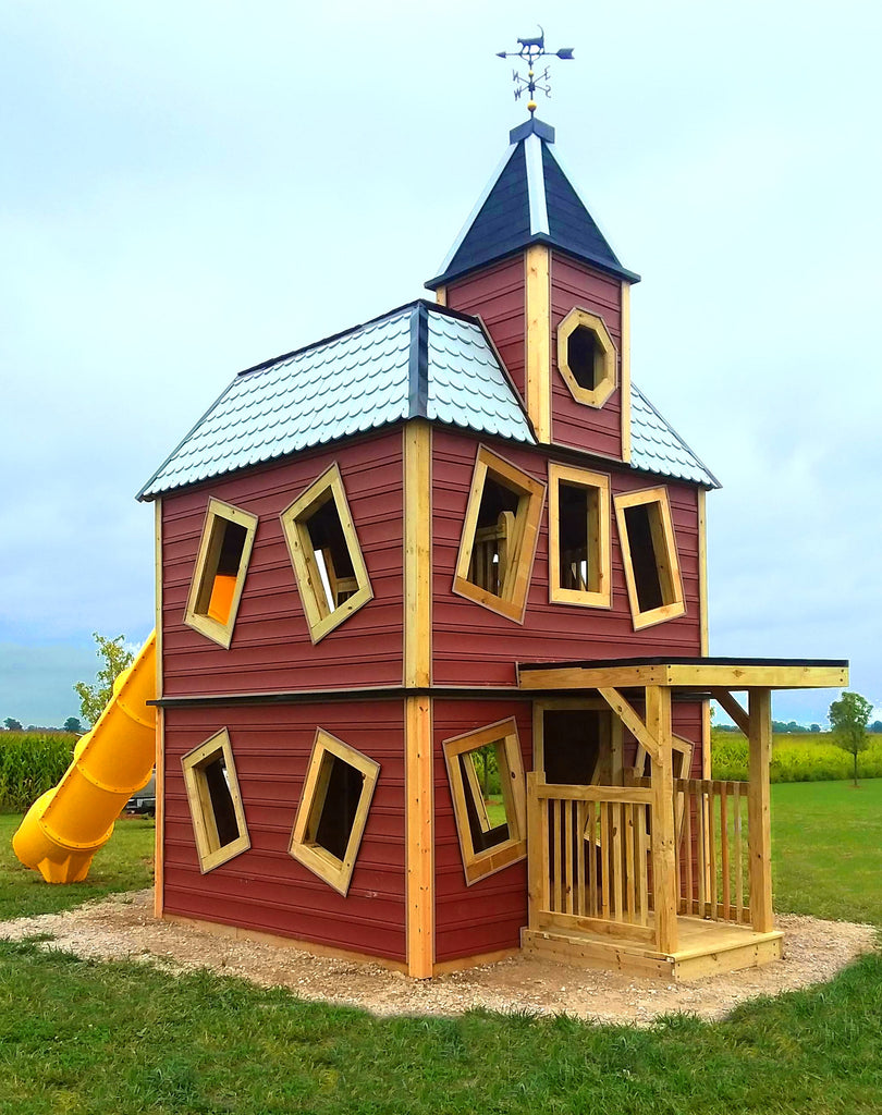Three level haunted house playhouse on a farm with a corn field.