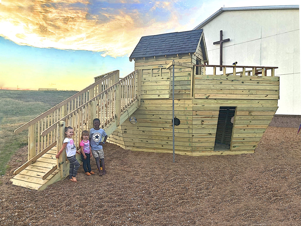 Wooden Noah's Ark themed playset outside of a church with children.