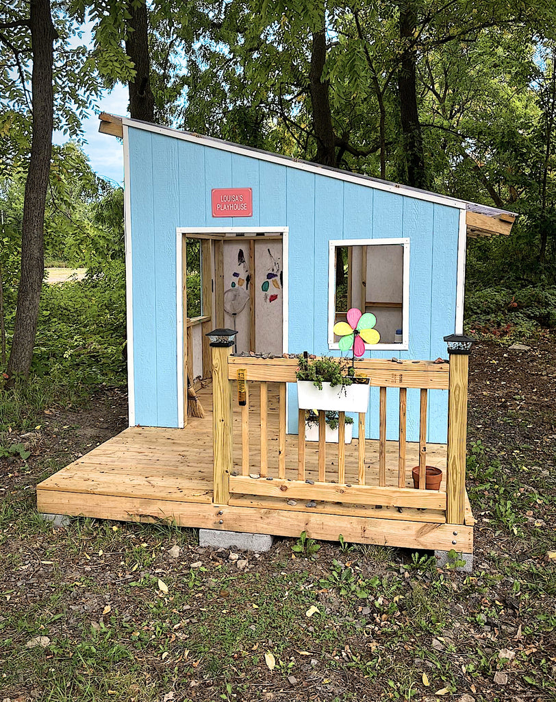 Free lean-to 8x8 playhouse with baby blue paint and front porch in the woods.