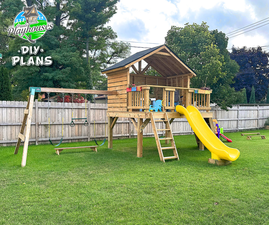 Wooden playhouse with a yellow slide and swing set on a grassy area with trees in the background.
