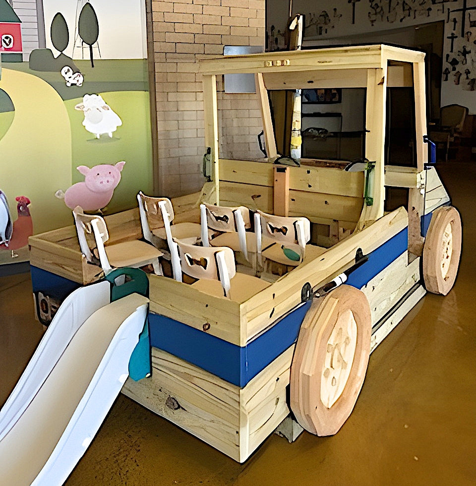 Wooden play vehicle with slide in a children's play area