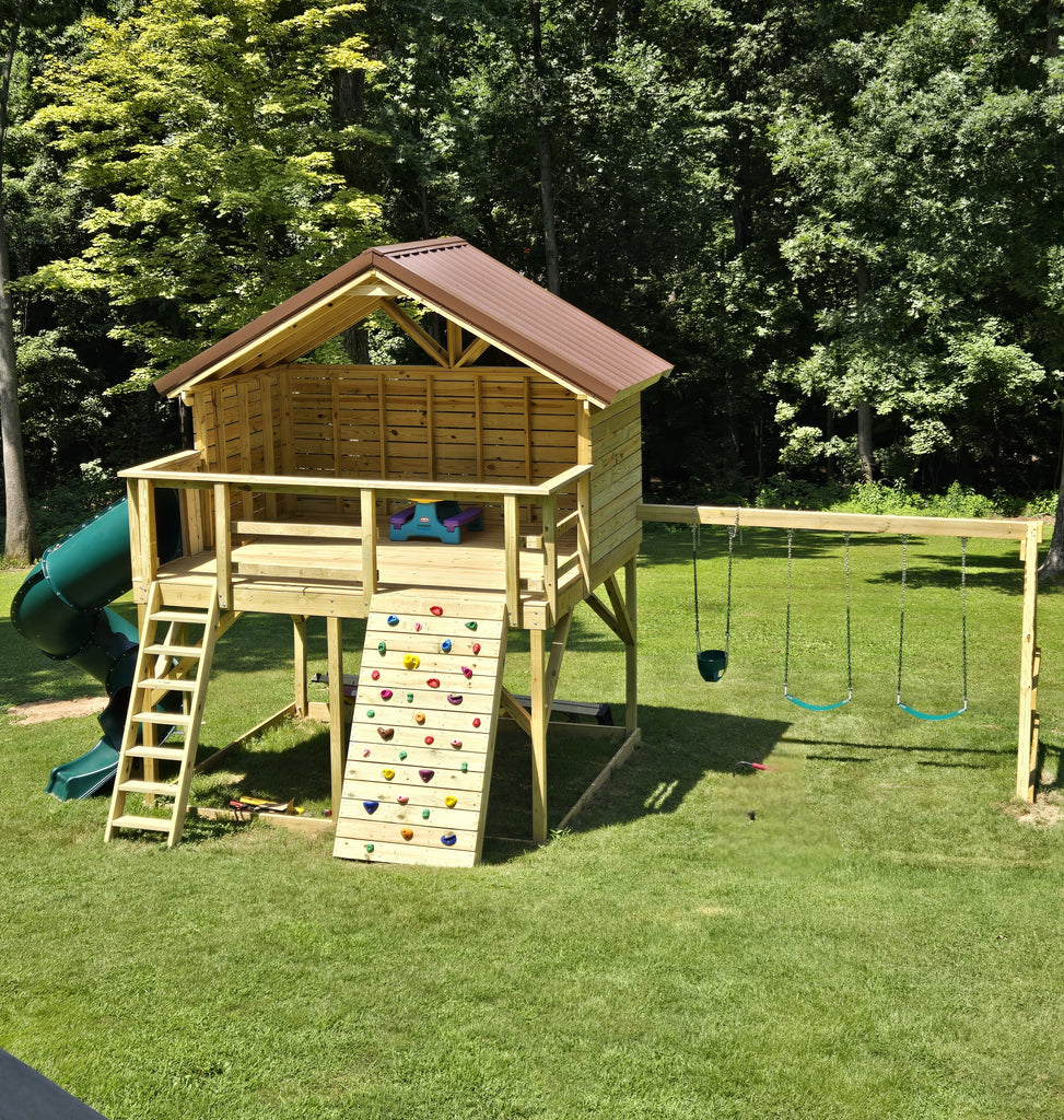 Open playground playhouse with rockwall, slide and swingset