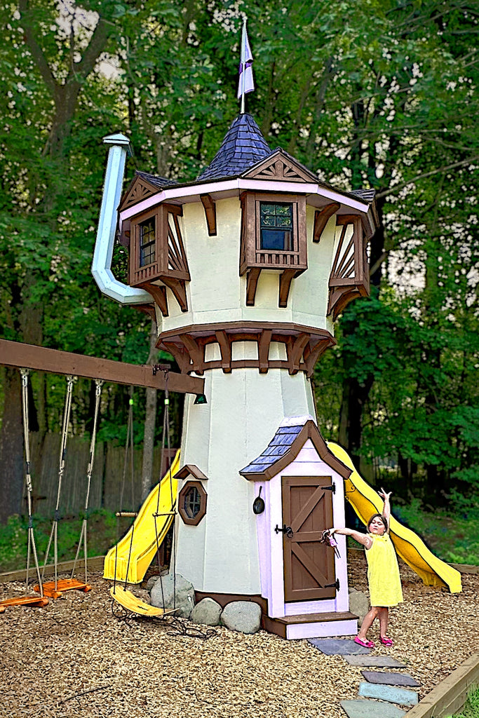 Whimsical Rapunzel-style play tower with slides and swings; girl in yellow dress poses cheerfully at the entrance.
