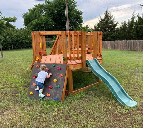 Toddler climbing small backyard playset