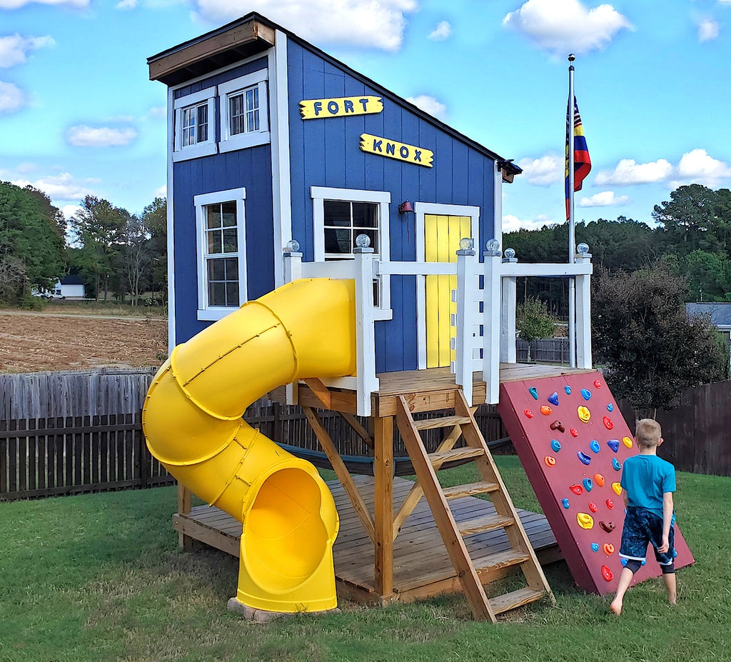 Blue and yellow, lean-to clubhouse with spiral side and rock wall