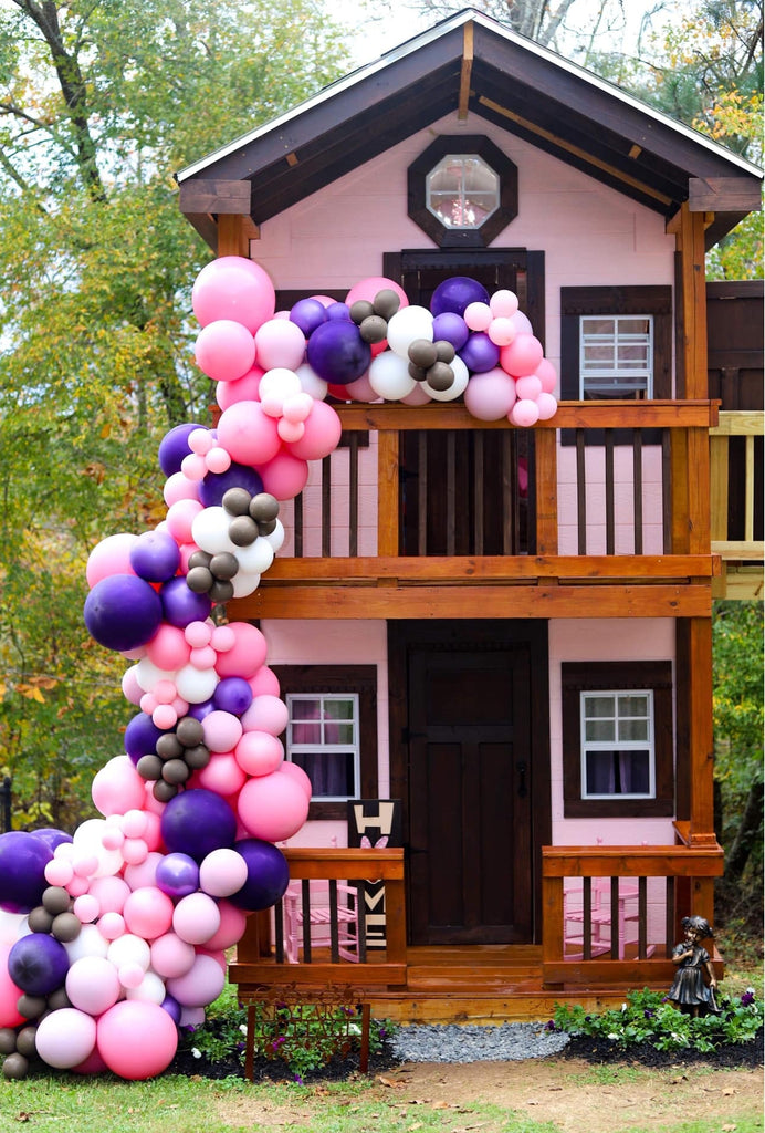 2 story, 2 deck pink playhouse with balloons