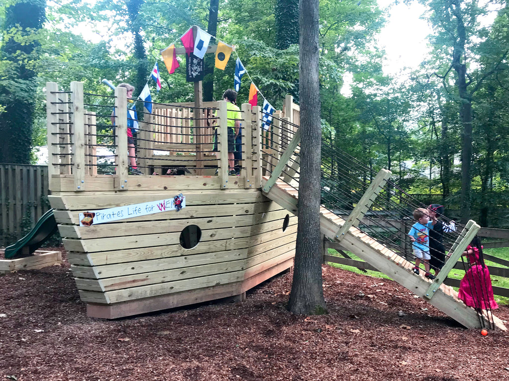 Children playing on a playground pirateship plan