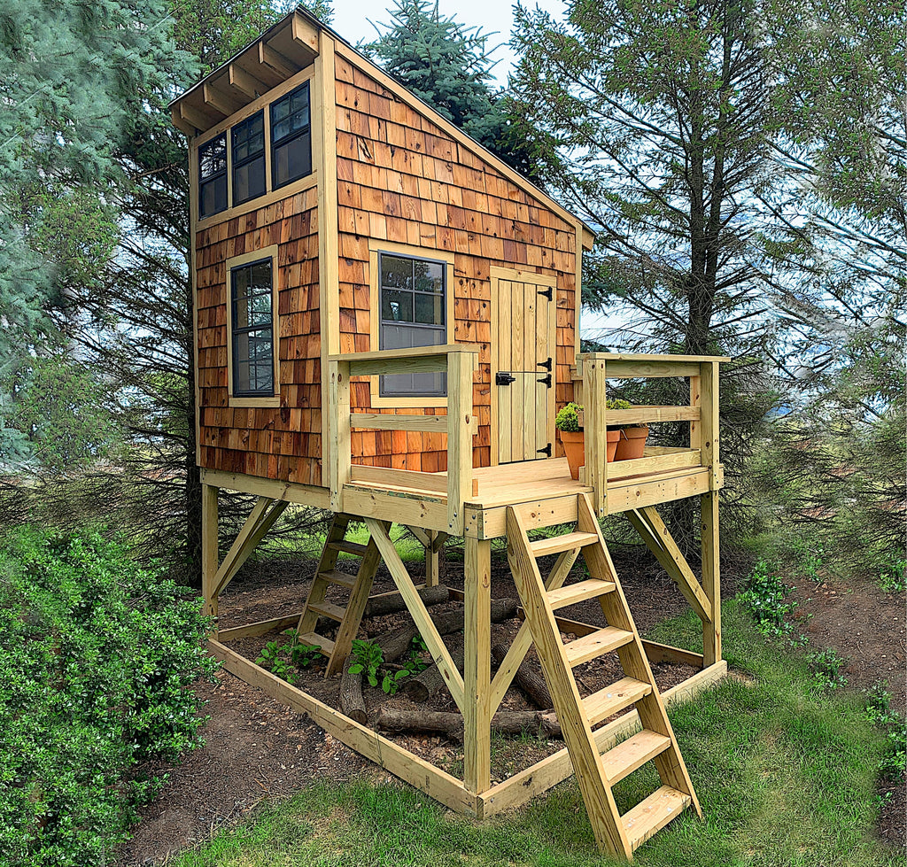 Elevated, lean-to roof playhouse with cedar shake siding and porch