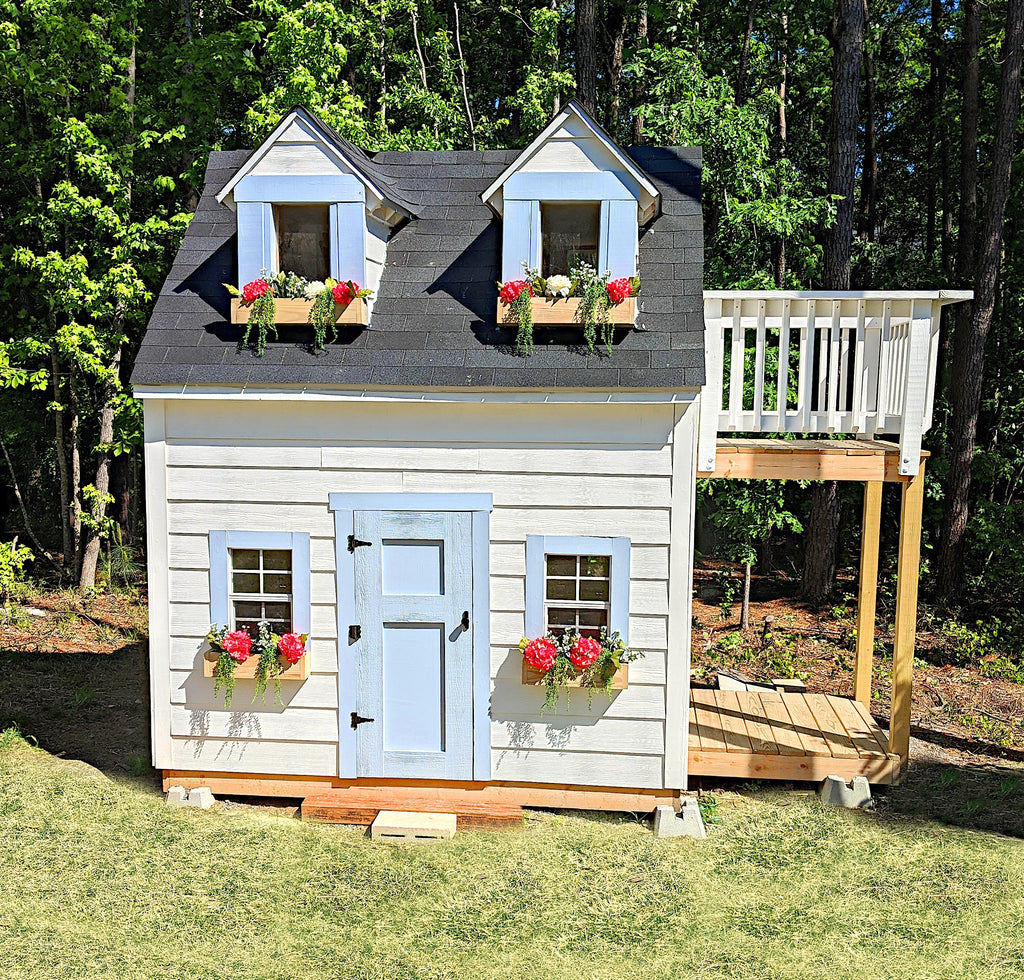 Beautiful white and blue girl's playhouse with flowerboxe, dormers and balcony