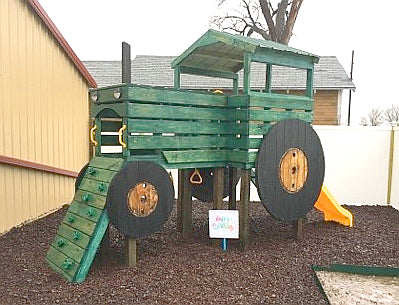 Elevated and modified, green painted tractor play-set