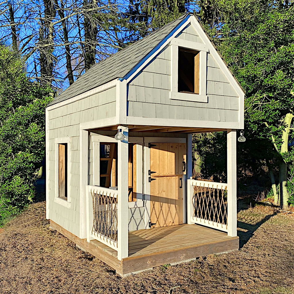 small gable playhouse with porch, shake siding and rope railing