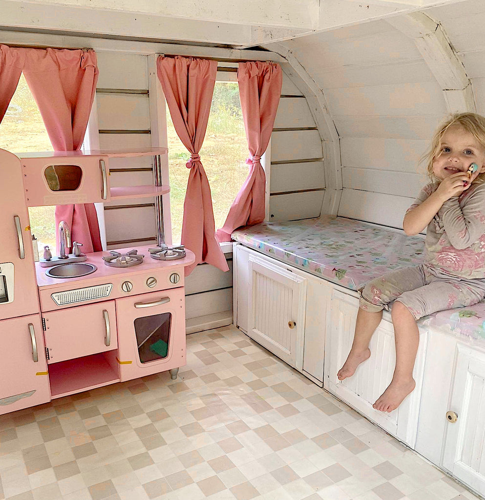 Camper playhouse with kitchen set, cabinets and little girl