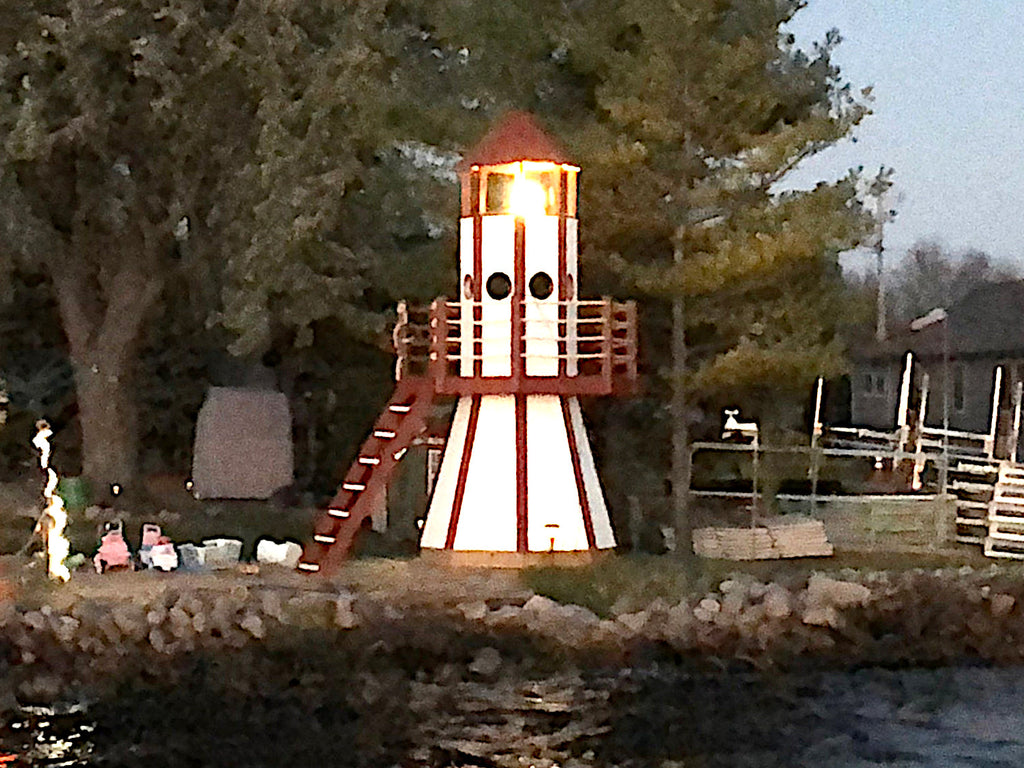 Red Lighthouse playhouse on lakeside