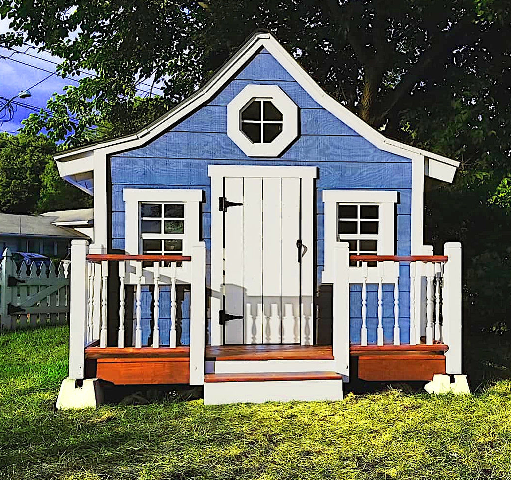Small blue playhouse with front porch in backyard