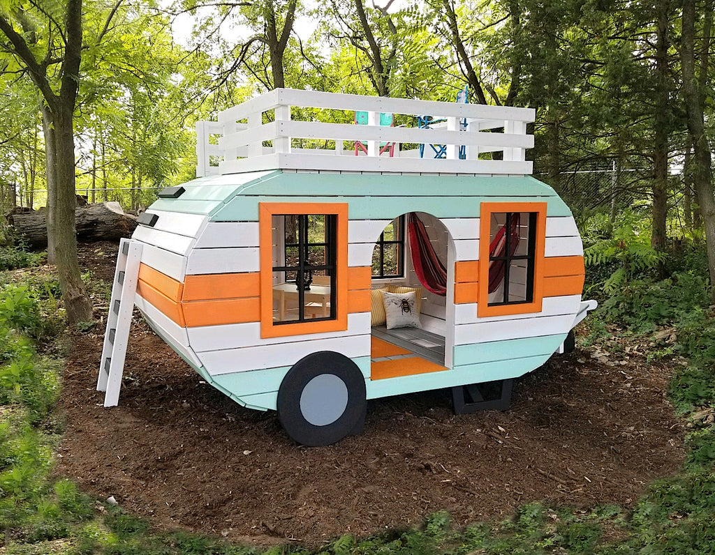 Blue and orange camper playset with a loft in the woods