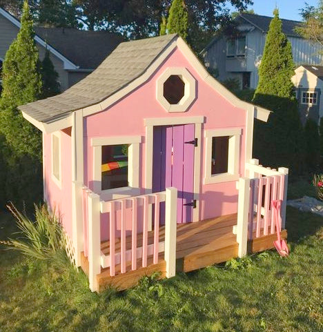 Small girl's pink playhouse with curved roof and porch