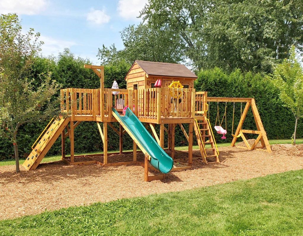 Elevated playset with playhouse and swing set in backyard