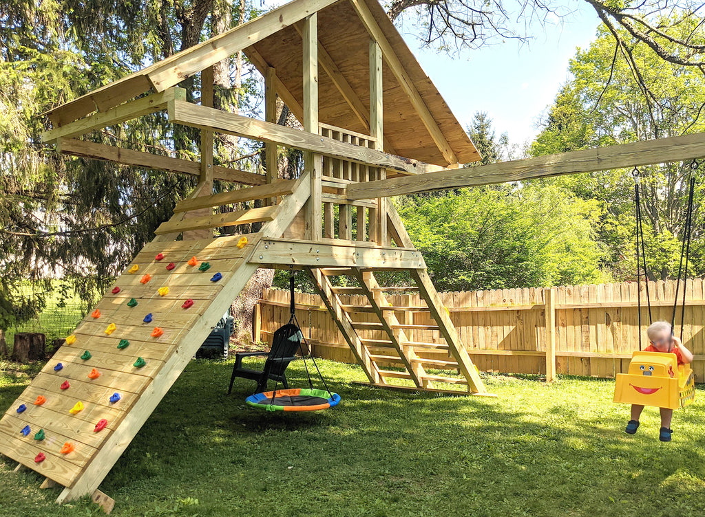 Backyard A-frame playset with rock wall 