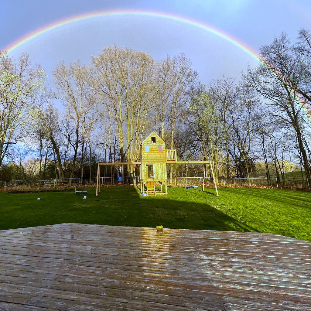 Rainbow over backyard playset