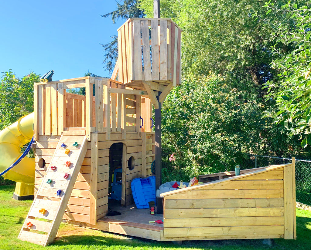 Small wooden pirate ship playset with crow's nest and rock wall