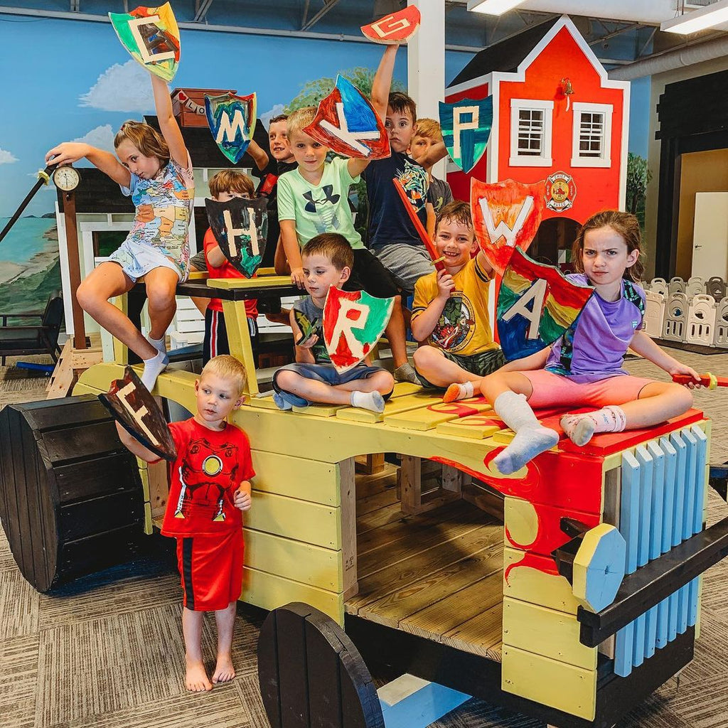 Kids playing on a wooden car playset