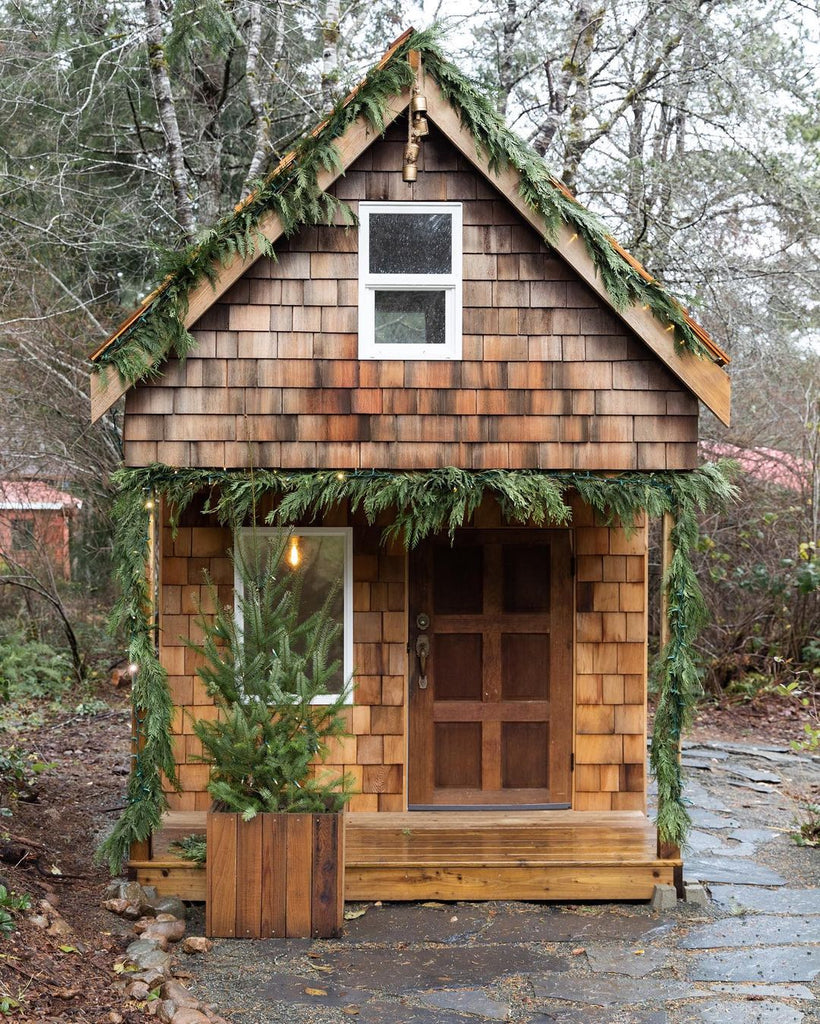 Cedar shake loft playhouse with Christmas garlands